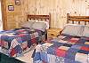 The 4th Bedroom of the cabin features 2 full size beds with lovely country patchwork quilts