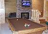 The fireplace in the gameroom area holds a 37" LCD Flatscreen TV and is open to both sides of the room with a sleeper sofa which offer extra sleeping room.