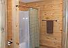 Bathroom in the lower level has a tub/shower unit with hotel rods that provide more shower room.