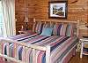 The Master Bedroom is located on the Main Level of the cabin with a King Size Bed and adjoining bathroom and access to the deck.