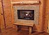 This gas burning fireplace is located in the Main Bedroom of the cabin.