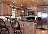 The spacious kitchen is equipped with Stainless Steel Appliances.  Bar provides seating for 2 the counter tops are cultured marble with custom tile backsplashes.