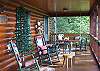 Relax on the covered front porch in one of the cabin in the Rocking Chairs, Porch Swing or Lounger Chair.