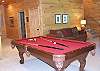 Family room on lower level with gas fireplace and Pool Table.  Exit to deck with Sundance Therapy Spa