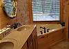 Relax in the Jacuzzi Tub located on the main level of the cabin with a custom tile shower also.