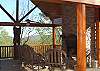 The outdoor fireplace on the beautiful deck of Bear Mtn Lodge offers you the ambiance of a warm woodburning fire and nice patio furniture for making memories with your family.