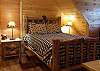 Queen Size bed in the upstairs bedroom with private bathroom
