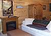 Family Room is on the Lower Level of the cabin. Foosball table, bumper pool table and Satellite TV, DVD, and VCR for your family entertainment. You can access the Hot Tub deck from this room.