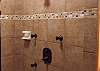 "Custom Tile Showers with Body Spray Shower Heads in All Three Bathrooms. The lower level shower is also a steam shower