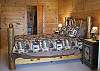 Queen Size Bed in the lower bedroom with bathroom and access to the lower deck area.