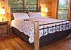 Relax and read your favorite book in the King Size log bed located in on the main level of the cabin