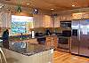 Fully furnished kitchen with stainless steel appliances, dishwasher, microwave, coffeemaker and more.  Oak cabinetry with granite counter tops. Bar with seating for 2