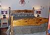 In the Lower Level Bedroom has a King Size Bed with a cowboy theme
