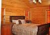 Queen Size Sleigh Bed in the Master Bedroom with a view from the bedroom of the Mountains
