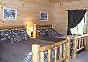 Bedroom downstairs has 2 full Log Beds which provides sleeping area for 4 more guests