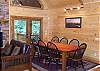 The dining room area provide access to the deck where the gas grill is located.