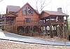 View of the Covered Decks and Wrap Around Porch.  Hot Tub and Wood Burning Fireplace with plenty of seating.  On the bottom deck you can play a game of ping pong. ( for our former guests our driveway is now Paved)