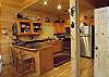 Kitchen is equipped with Stainless Steel Appliances with accesss to the dining table and extra seating provided at the bar.