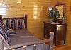 The second bedroom is located on the main floor with a Log Twin Bed.