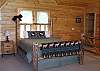 There is a Queen Size Log Bed located in the Loft area also has access to full bathroom. You can enjoy the longe range mountain view from this area of the cabin.