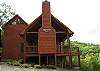 You will walk upon the covered porch which houses the wood burning fireplace and an awesome mountain view.