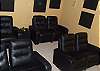 Theatre room provides seating for up to 8 guests for enjoying a night at the movies.