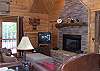 The Living Room is situated around the gas log fireplace.  The TV is equipped with sattelite system by Direct TV