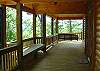 Entrance of cabin with Porch Swing and Seat