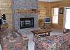 Family Room downstairs centered around the gas log fireplace with access to the outdoor patio with Hot Tub and Fire Pit.