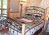 Queen Bed on the Main Level with access to a private bathroom and the living room and kitchen area