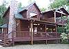 Looking at the front side of the cabin you can see the covered porch and the private covered deck off the Master Bedroom