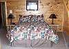 Queen Bed in the Upstairs Bedroom with access to private deck.