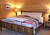 Kingsize Log Bed with Log furnishings on the lower level of cabin