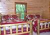 2 double full/ log beds with lovely quilted comforters  in the lower level bedroom with bathroom located directly across the hallway.