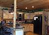 Fully Equipped Kitchen with bar seating for 3, Oven, Microwave, Refrigerator, Dishwasher, and Coffeemaker.