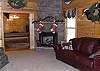 The living room is situated around the stack stone gas log fireplace