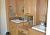 Double Sinks.  Toilet and Walk-In Closet Separated from Bathroom by Doors.
