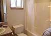 Shower-tub combo in the main bath on upper level.