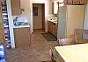 Game table open to kitchen, not equipped for preparing meals