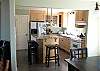 Granite Counters on Island.  Huge Pantry behind White Door.