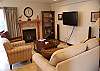 State-of-the-art entertainment in the living room with cozy gas fireplace.