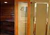 Sauna Door Stands Open.  Step-In Shower Door on Right.