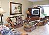 The living room with island furnishings-windows to the lanai