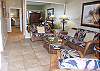 Looking in from the lanai, you can see down the hallway (half bath to the right, entry door to the left) all the way to the bedroom.