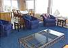 Upstairs Living Room with new couch and chairs, wood burning fire place with TV and stereo system