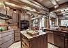 The island in the center of the kitchen offers a butcherblock counter - Bear Lodge Breckenridge Vacation Rental 