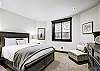 Lower level queen bedroom with flat screen TV and en-suite bathroom. -  The Bogart House Breckenridge Vacation Rental 