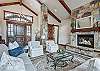 Cozy up by the fireplace in this spacious main living area - Breck Escape Breckenridge Vacation Rental  