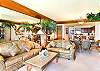 The living room, looking in toward the kitchen and dining area