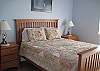 Queen bed and access to the patio by the pond.